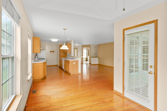 213 Stillwater Ct, Oswego, IL 60543 - kitchen with light wood-type flooring, light countertops, open floor plan, decorative light fixtures, and dishwasher