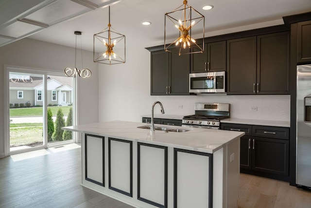 LOT15 Buckboard Ln Unit C, Sycamore, IL 60178 - kitchen with appliances with stainless steel finishes, a sink, a chandelier, light wood finished floors, and light stone countertops
