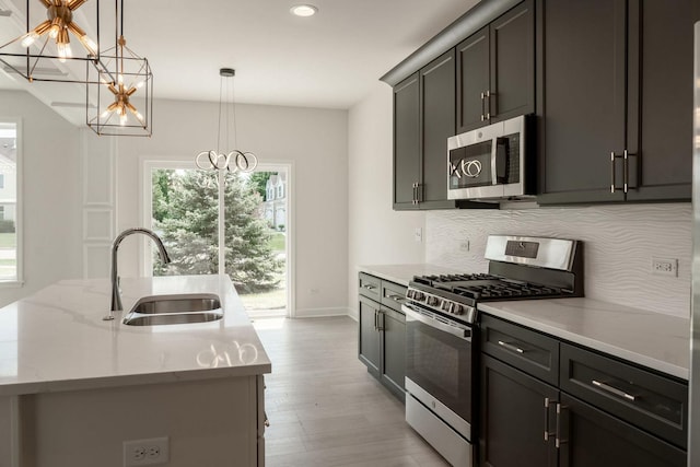LOT15 Buckboard Ln Unit C, Sycamore, IL 60178 - kitchen featuring appliances with stainless steel finishes, a sink, a chandelier, plenty of natural light, and recessed lighting