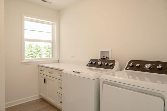 LOT15 Buckboard Ln Unit C, Sycamore, IL 60178 - laundry room featuring washing machine and dryer, cabinet space, light wood finished floors, and baseboards