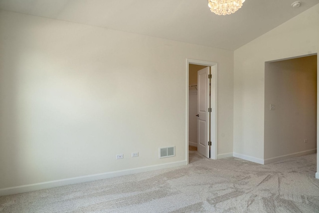 LOT15 Buckboard Ln Unit C, Sycamore, IL 60178 - spare room with carpet floors, lofted ceiling, baseboards, a chandelier, and a smoke detector