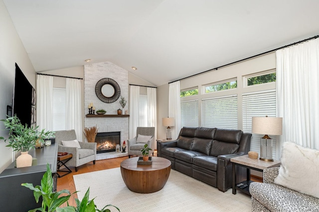 407 Anthony Ct, Oswego, IL 60543 - living room featuring vaulted ceiling, a fireplace, and wood finished floors