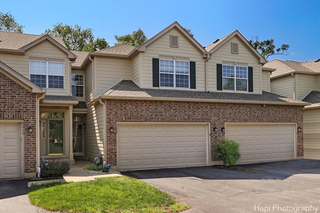 5208 Cobblers Xing Unit 5208, Mchenry, IL 60050 - townhome / multi-family property featuring brick siding, driveway, a garage, and a shingled roof
