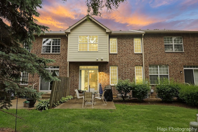5208 Cobblers Xing Unit 5208, Mchenry, IL 60050 - back of property with a patio, a lawn, and brick siding