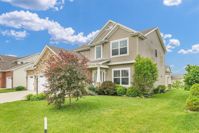 2107 Max Run Dr E, Champaign, IL 61822 - craftsman house featuring driveway, a front lawn, and an attached garage