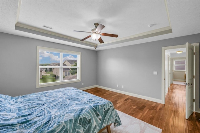 2107 Max Run Dr E, Champaign, IL 61822 - bedroom featuring a tray ceiling, a textured ceiling, wood finished floors, and ceiling fan