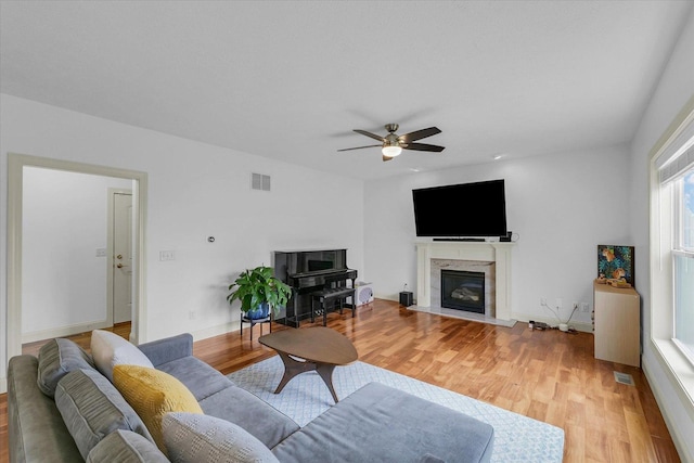 2107 Max Run Dr E, Champaign, IL 61822 - living area featuring light wood-style floors, a ceiling fan, and a fireplace