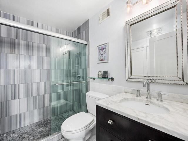 1030 N State St Unit 44L, Chicago, IL 60610 - bathroom with toilet, vanity, and a shower stall