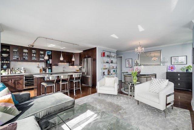 1030 N State St Unit 44L, Chicago, IL 60610 - living area with wine cooler, ornamental molding, a chandelier, track lighting, and wood finished floors