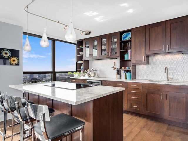 1030 N State St Unit 44L, Chicago, IL 60610 - kitchen featuring open shelves, a sink, black electric cooktop, and tasteful backsplash