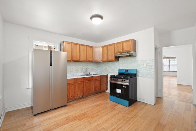 11219 S Wallace St, Chicago, IL 60628 - kitchen featuring appliances with stainless steel finishes, under cabinet range hood, a sink, and tasteful backsplash