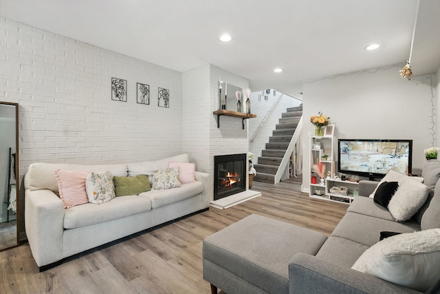 534 W Eugenie St, Chicago, IL 60614 - living area with brick wall, wood finished floors, stairs, and recessed lighting