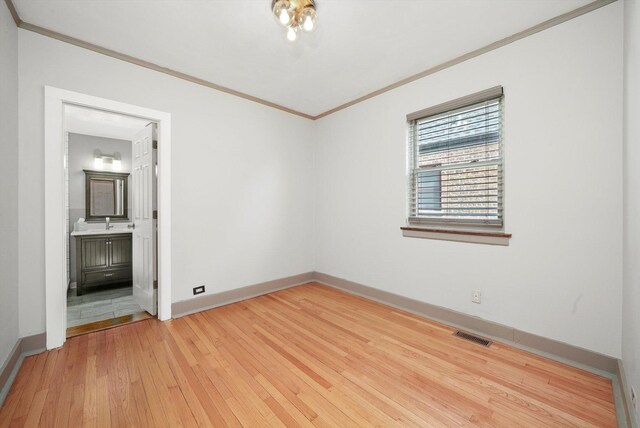 9316 S Utica Ave, Evergreen Park, IL 60805 - empty room with crown molding and light wood-type flooring