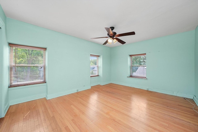 9316 S Utica Ave, Evergreen Park, IL 60805 - unfurnished room featuring light wood-style floors, healthy amount of natural light, and ceiling fan