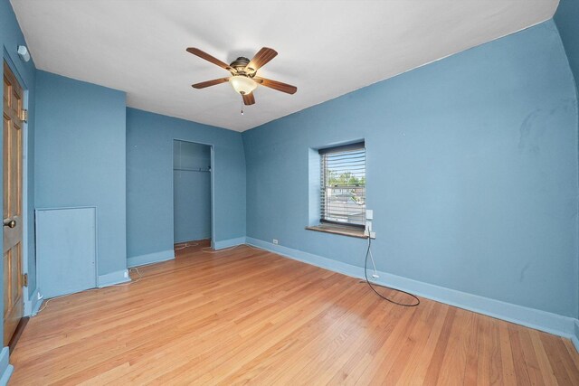 9316 S Utica Ave, Evergreen Park, IL 60805 - unfurnished bedroom featuring a closet, light wood finished floors, and a ceiling fan