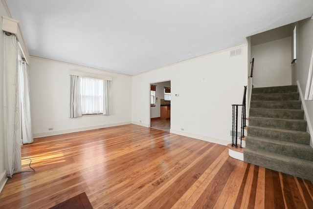 9316 S Utica Ave, Evergreen Park, IL 60805 - unfurnished living room with light wood-style flooring and stairway