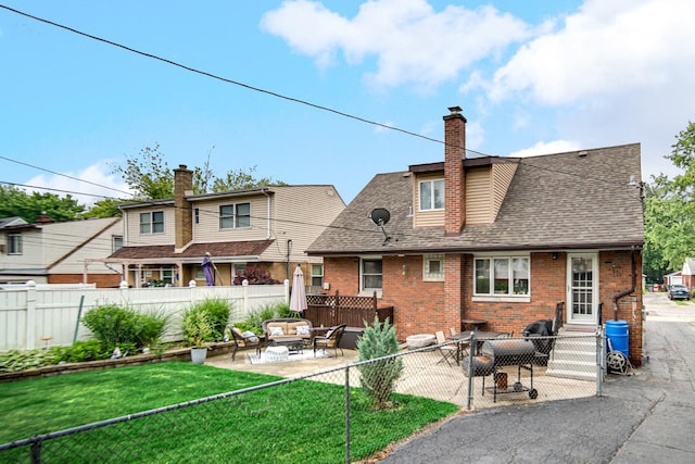 18625 Lexington Ave, Homewood, IL 60430 - rear view of house featuring brick siding, roof with shingles, a patio area, a chimney, and outdoor lounge area