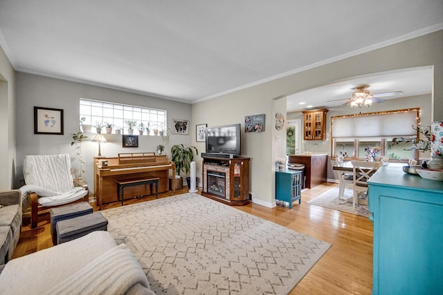 18625 Lexington Ave, Homewood, IL 60430 - living area featuring light wood-style floors, crown molding, a ceiling fan, and arched walkways