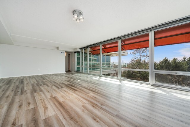 9715 Woods Dr Unit 700, Skokie, IL 60077 - empty room featuring wood finished floors and a wall of windows