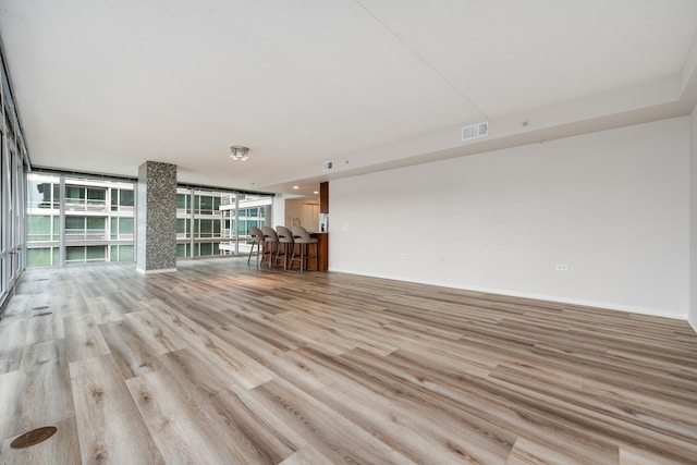 9715 Woods Dr Unit 700, Skokie, IL 60077 - unfurnished living room featuring wood finished floors and a wall of windows