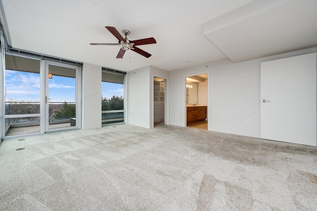 9715 Woods Dr Unit 700, Skokie, IL 60077 - unfurnished bedroom with carpet, access to exterior, a walk in closet, ensuite bath, and a wall of windows