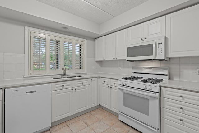 730 Creekside Dr Unit 104, Mount Prospect, IL 60056 - kitchen featuring white appliances, a textured ceiling, light countertops, white cabinets, and tasteful backsplash