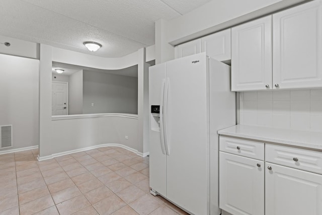 730 Creekside Dr Unit 104, Mount Prospect, IL 60056 - kitchen featuring white refrigerator with ice dispenser, white cabinets, light countertops, a textured ceiling, and light tile patterned floors