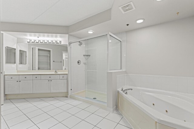 730 Creekside Dr Unit 104, Mount Prospect, IL 60056 - bathroom with a jetted tub, a shower stall, vanity, tile patterned floors, and recessed lighting