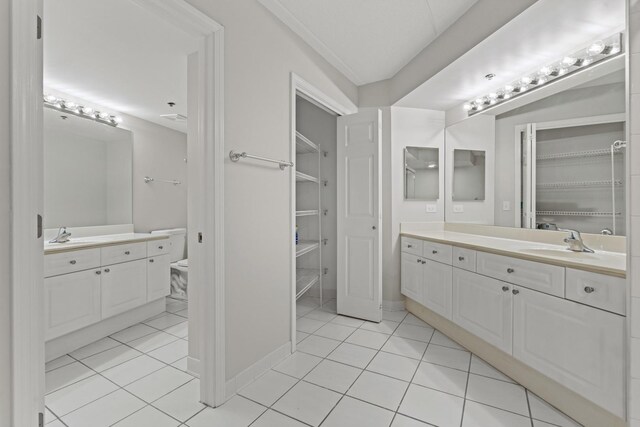 730 Creekside Dr Unit 104, Mount Prospect, IL 60056 - full bathroom with a spacious closet, two vanities, and tile patterned floors