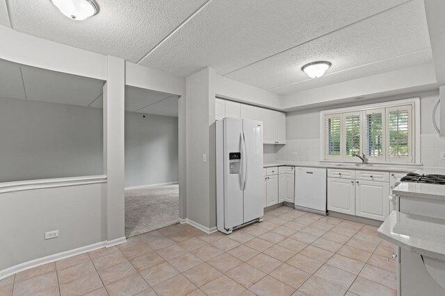 730 Creekside Dr Unit 104, Mount Prospect, IL 60056 - kitchen with white appliances, a textured ceiling, white cabinetry, light tile patterned flooring, and backsplash