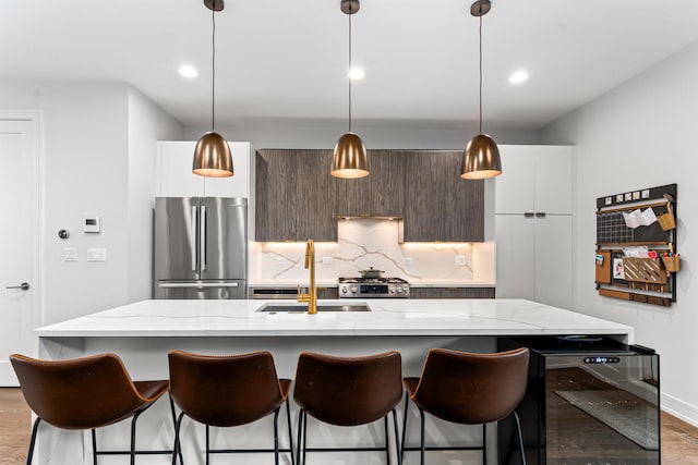 1410 N Greenview Ave Unit 1, Chicago, IL 60642 - kitchen with stainless steel appliances, wine cooler, modern cabinets, a kitchen bar, and recessed lighting