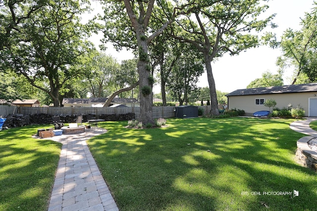 38159 N Geraghty Ave, Beach Park, IL 60087 - fenced backyard with a fire pit, a shed, and a patio area