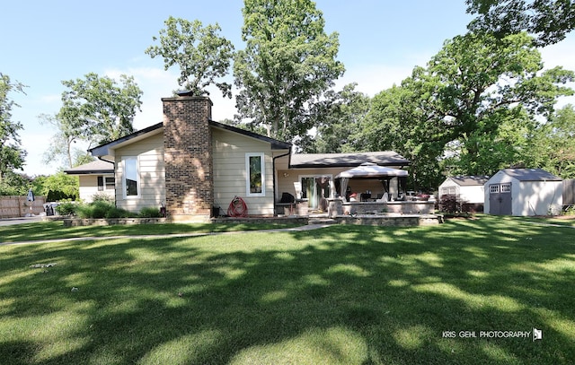 38159 N Geraghty Ave, Beach Park, IL 60087 - rear view of property with a storage unit, a gazebo, a yard, and a chimney