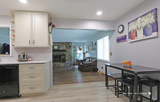 38159 N Geraghty Ave, Beach Park, IL 60087 - kitchen featuring dishwasher, light countertops, light wood-style floors, open shelves, and a stone fireplace