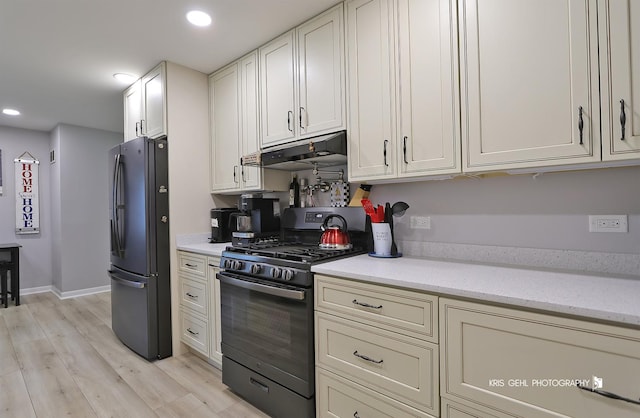 38159 N Geraghty Ave, Beach Park, IL 60087 - kitchen featuring freestanding refrigerator, black gas range oven, under cabinet range hood, light wood-style floors, and recessed lighting