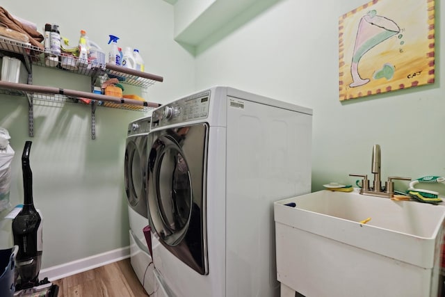 12820 Tipperary Ln, Plainfield, IL 60585 - washroom featuring separate washer and dryer and light wood-style flooring