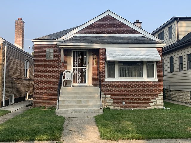6210 S Keeler Ave, Chicago, IL 60629 - bungalow-style home featuring brick siding, a front yard, and a chimney