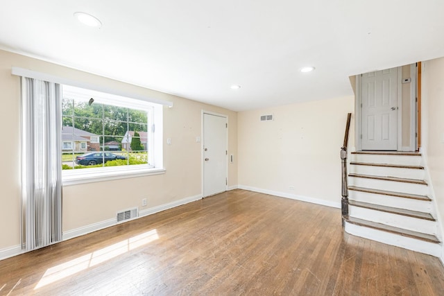 9626 S Oglesby Ave, Chicago, IL 60617 - unfurnished living room with wood finished floors, recessed lighting, and stairway