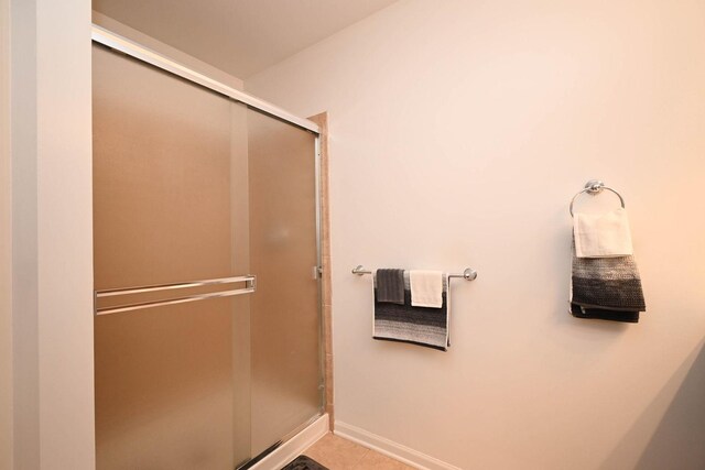 39735 N Paris Dr, Beach Park, IL 60083 - bathroom featuring a stall shower, tile patterned floors, and baseboards