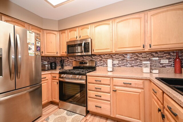 39735 N Paris Dr, Beach Park, IL 60083 - kitchen with stainless steel appliances, light brown cabinets, backsplash, and light countertops