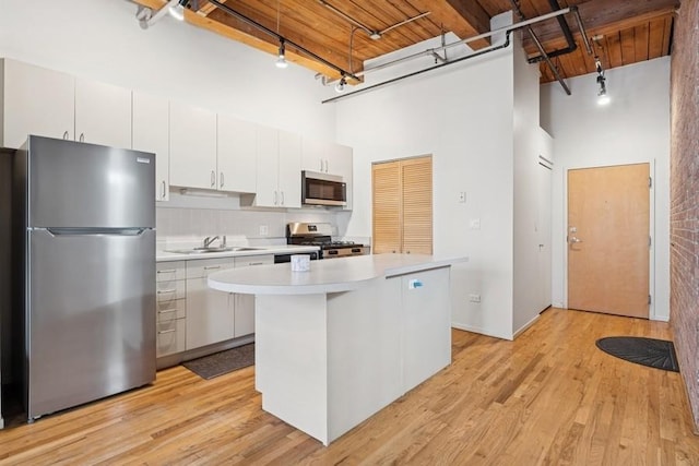 420 S Clinton St Unit 614A, Chicago, IL 60607 - kitchen with stainless steel appliances, a towering ceiling, track lighting, light countertops, and a sink