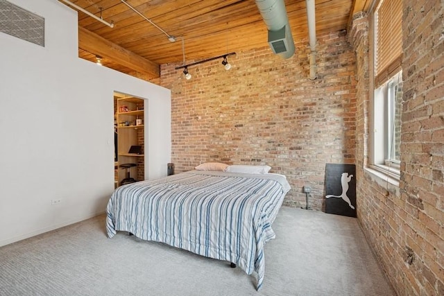 420 S Clinton St Unit 614A, Chicago, IL 60607 - bedroom featuring rail lighting, wood ceiling, brick wall, carpet floors, and a spacious closet