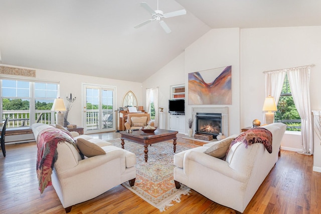 5284 Harvey Rd, Caledonia, IL 61011 - living area featuring high vaulted ceiling, healthy amount of natural light, a fireplace with flush hearth, light wood-type flooring, and a ceiling fan