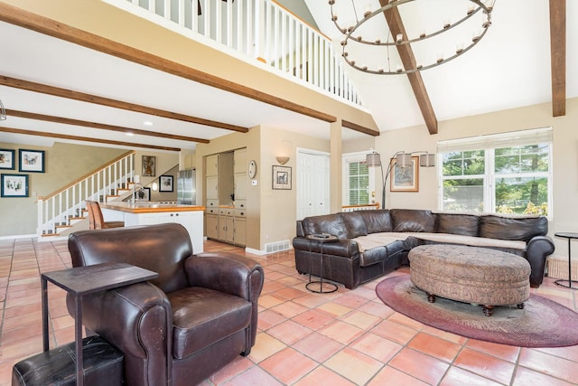 5284 Harvey Rd, Caledonia, IL 61011 - living room with stairway, beamed ceiling, light tile patterned floors, a chandelier, and high vaulted ceiling