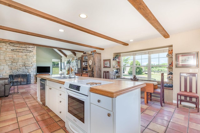 5284 Harvey Rd, Caledonia, IL 61011 - kitchen featuring white electric stove, white cabinets, open floor plan, healthy amount of natural light, and recessed lighting