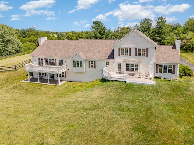 5284 Harvey Rd, Caledonia, IL 61011 - back of house featuring a chimney, a wooden deck, and a shingled roof
