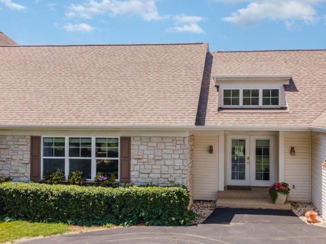 5284 Harvey Rd, Caledonia, IL 61011 - view of front of home featuring french doors, stone siding, and roof with shingles