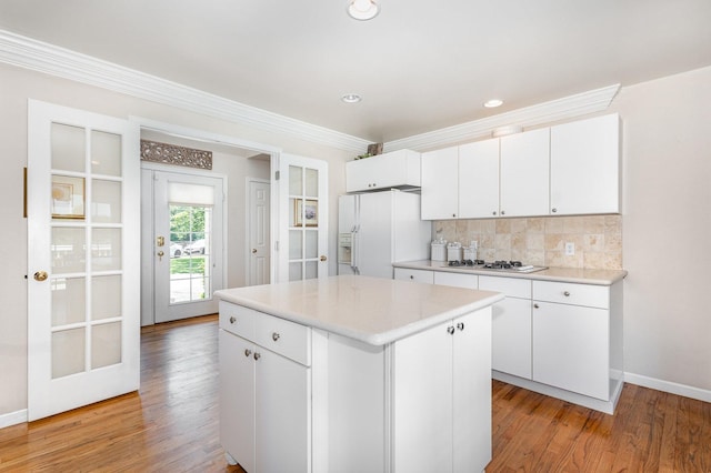 5284 Harvey Rd, Caledonia, IL 61011 - kitchen featuring white appliances, light wood finished floors, white cabinets, light countertops, and ornamental molding