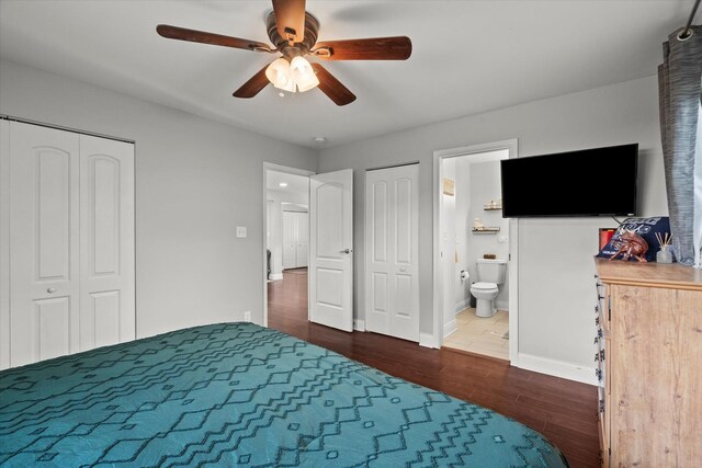 427 Cedarcrest Dr, Streamwood, IL 60107 - bedroom with dark wood-style floors, baseboards, connected bathroom, a ceiling fan, and multiple closets