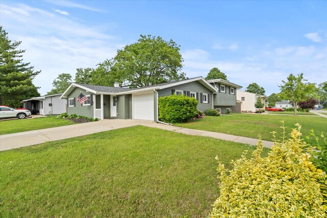 427 Cedarcrest Dr, Streamwood, IL 60107 - tri-level home with driveway, a front yard, an attached garage, and a chimney